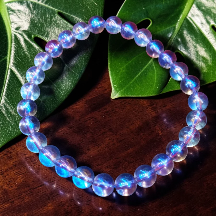 bracelet aqua aura 06mm pierre naturelle transparente au reflet arc en ciel avec traitement par vaporisation au titane et or